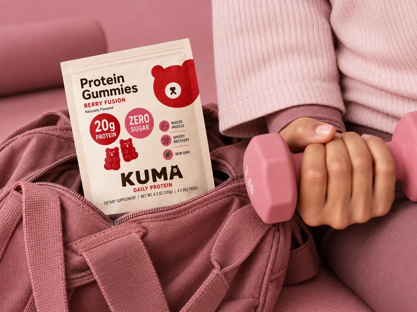 Kuma pouch tucked in a dusty pink gym bag beside a pink dumbbell